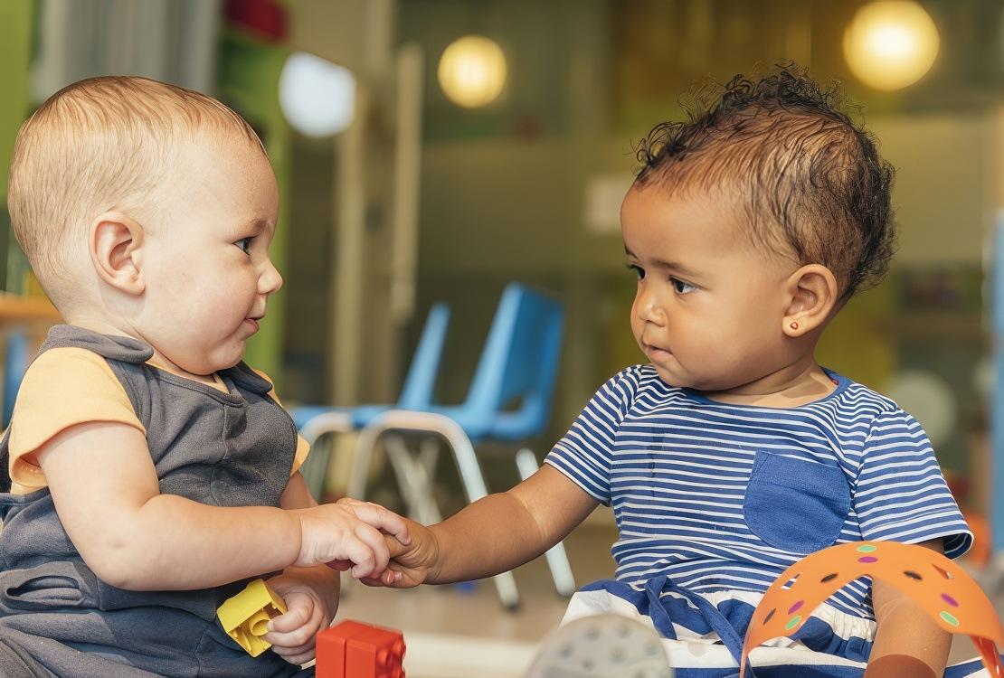 Two babies playing together in Daycare