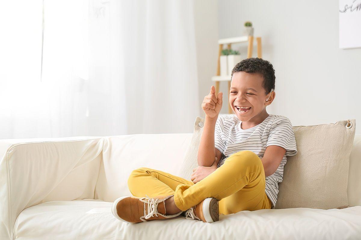 A boy with a hearing aid. Part of the Family Support and Healthcare Alliance Delaware (SHADE) program