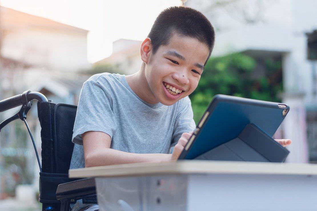 A boy using a tablet as part of the Family Support and Healthcare Alliance Delaware (SHADE) program