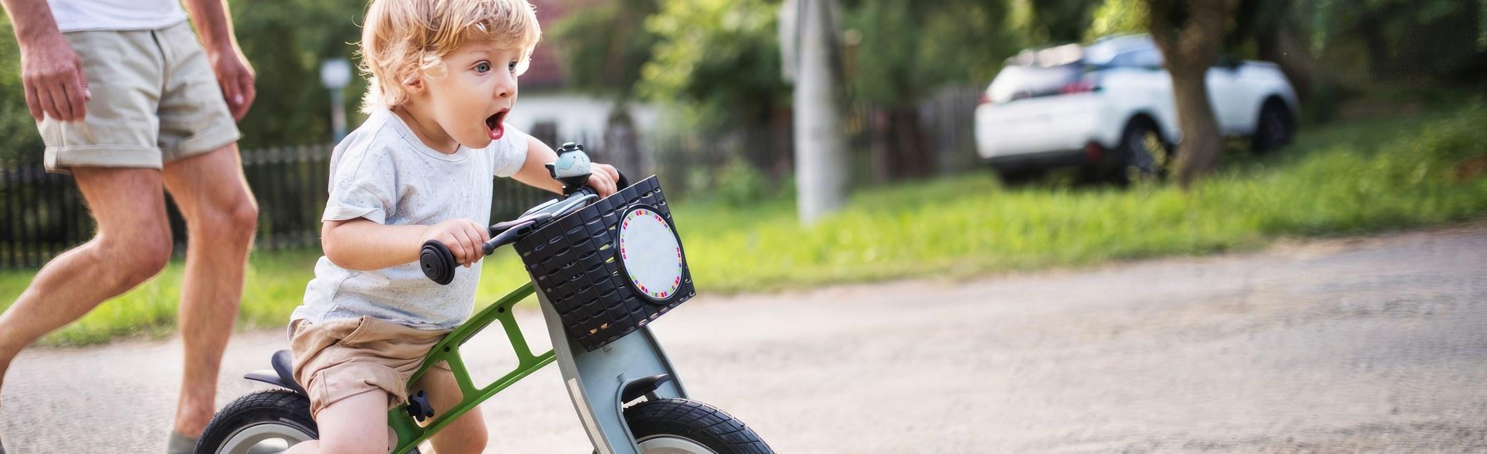 A childhood milestone, a child learning to ride a bike