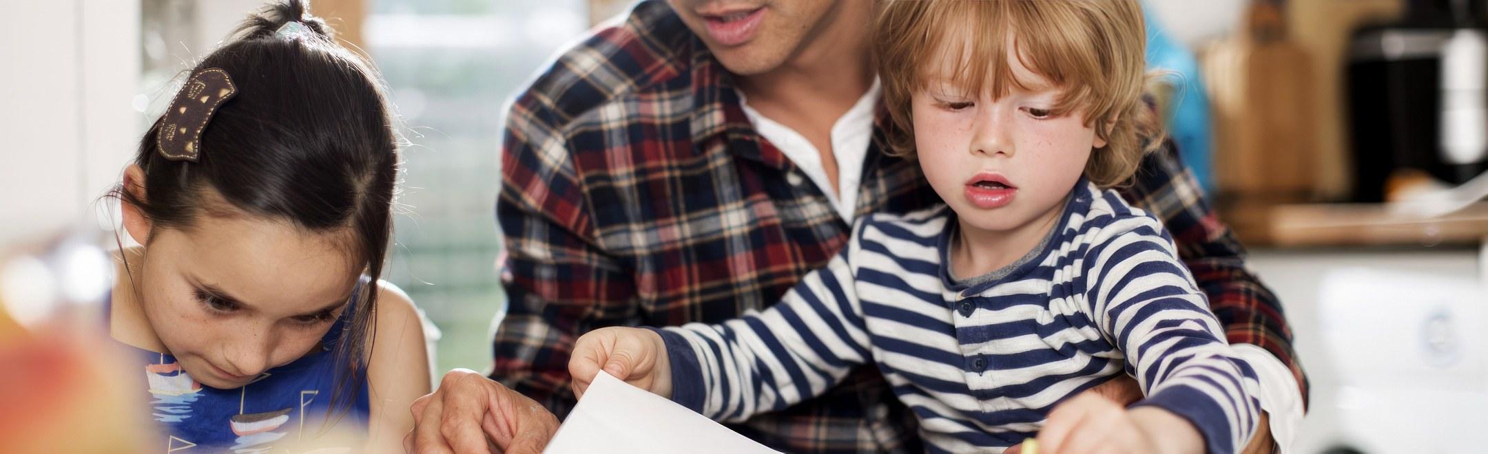 DELAWARE MILESTONES: A father coloring with his children