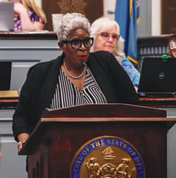 A legislator speaking at a podium