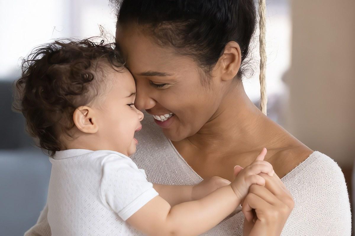 Mother holding baby smiling