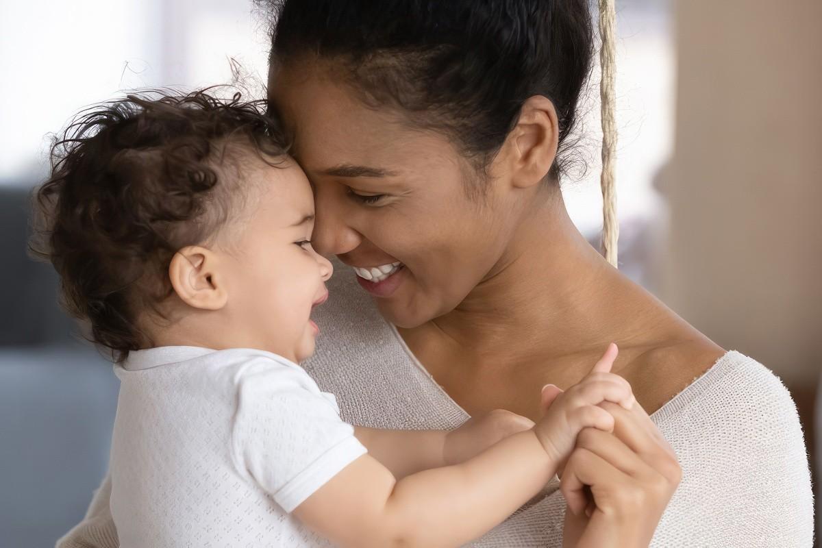 Mother holding baby smiling