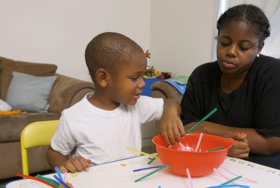 A child age 0-3 and his mom playing inside.