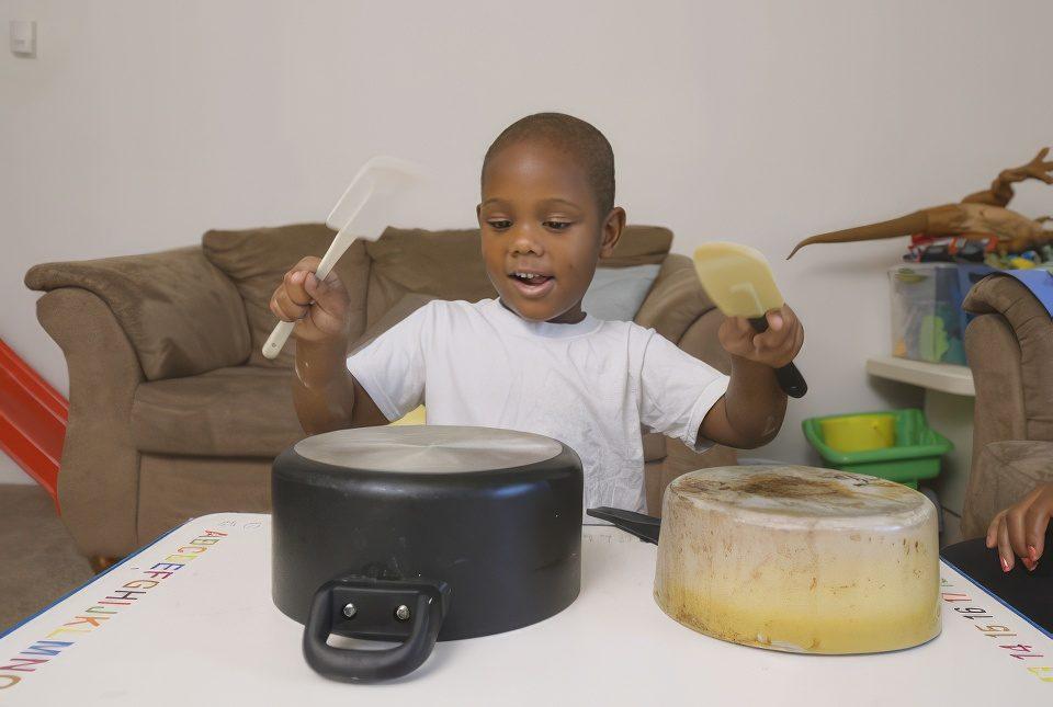 A child age 4-8 and his mom playing inside.