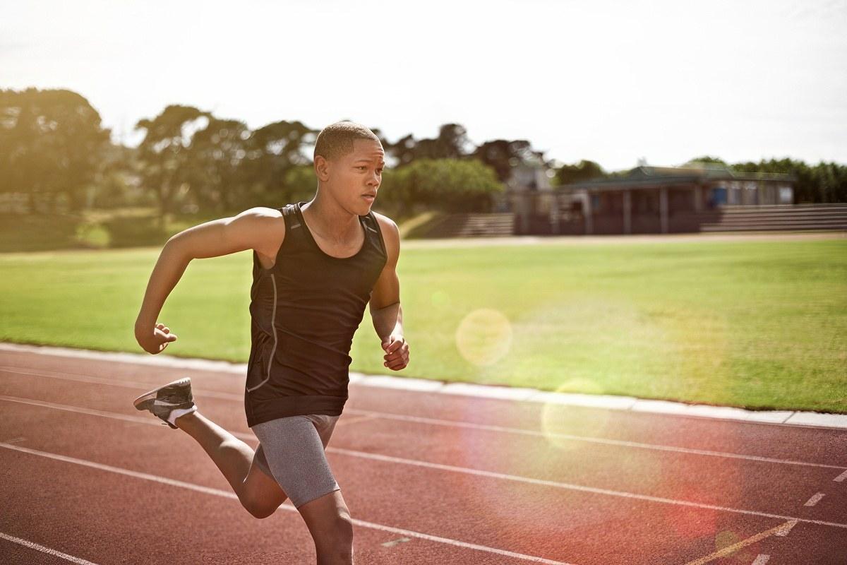 Teen running track as part of taking care of his physical health