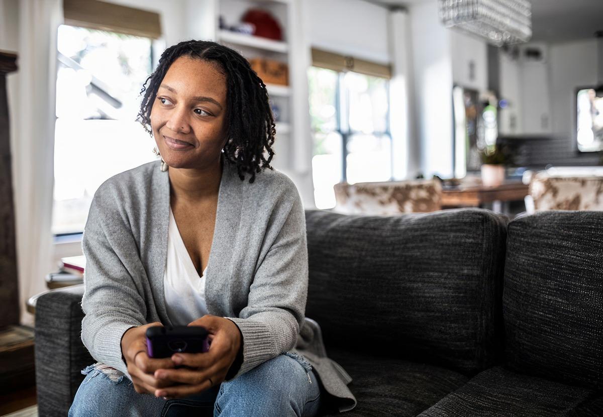 Healthy woman on phone thinking